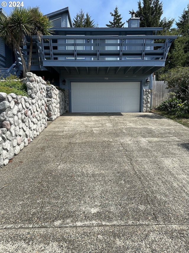 view of front of house featuring a balcony and a garage