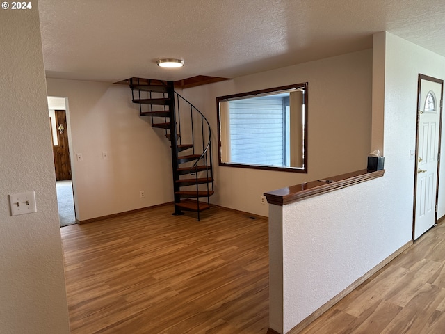 interior space with hardwood / wood-style floors and a textured ceiling