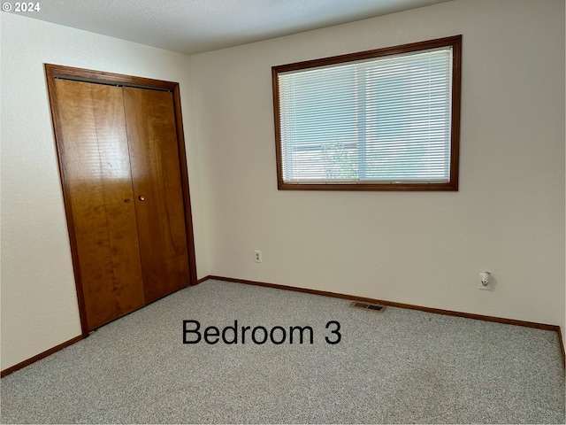 unfurnished bedroom featuring a closet and carpet