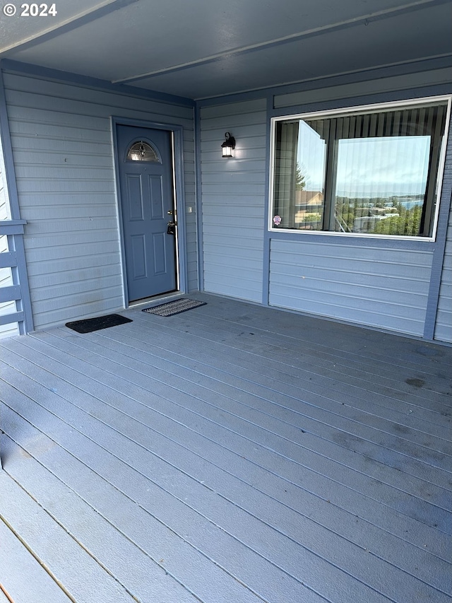 view of exterior entry featuring covered porch