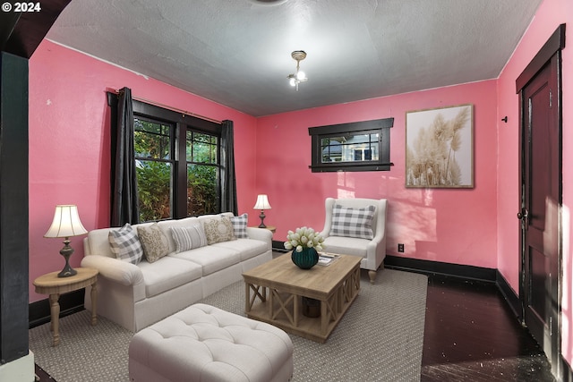 carpeted living room with a textured ceiling