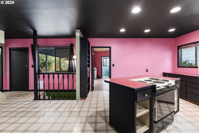 kitchen with black range oven and a kitchen island