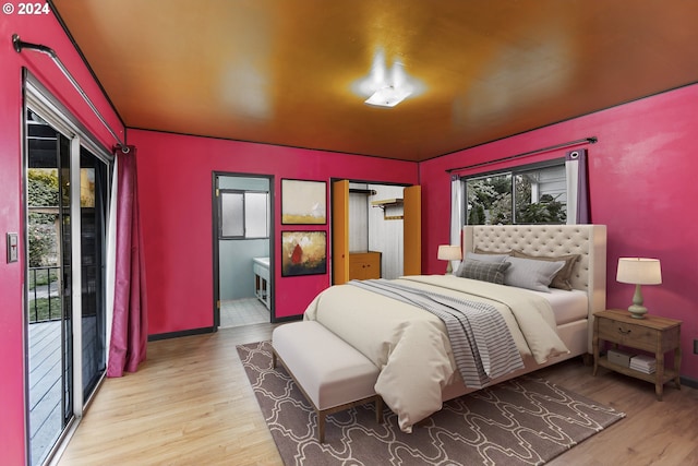 bedroom featuring access to outside and light hardwood / wood-style flooring