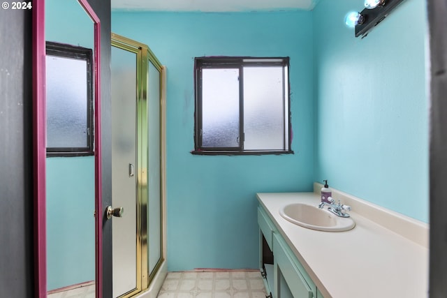 bathroom with walk in shower and vanity