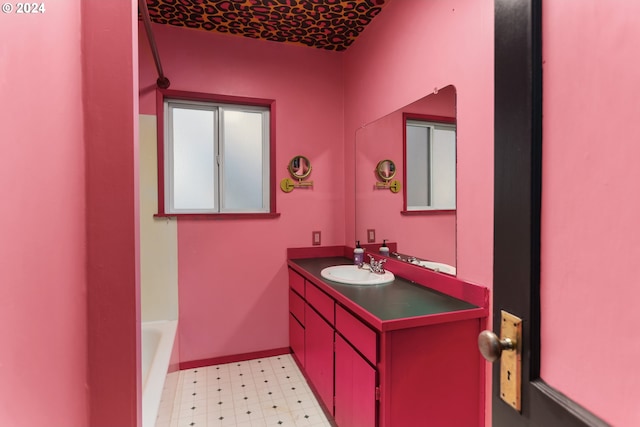 bathroom featuring a washtub and vanity