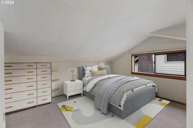 bedroom featuring lofted ceiling and light colored carpet