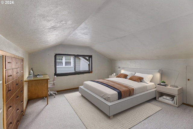 bedroom featuring light carpet, vaulted ceiling, and a textured ceiling