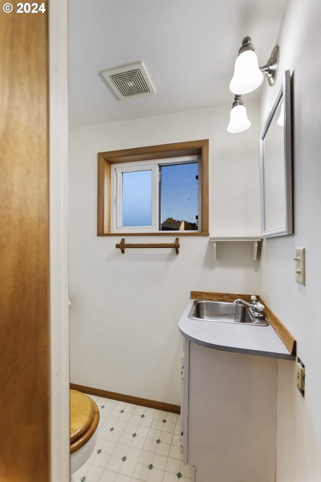 bathroom featuring vanity and toilet