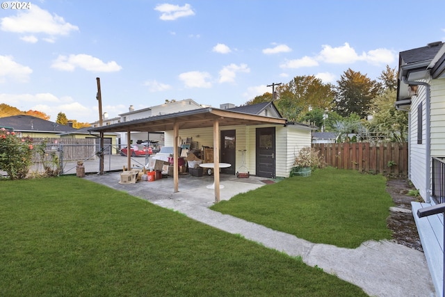 back of house with a yard and a patio area