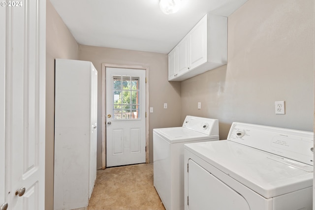 laundry room with independent washer and dryer and cabinets