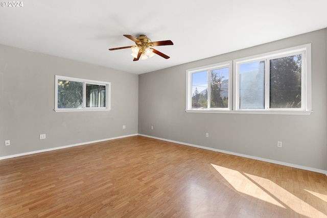 spare room featuring ceiling fan and light hardwood / wood-style flooring