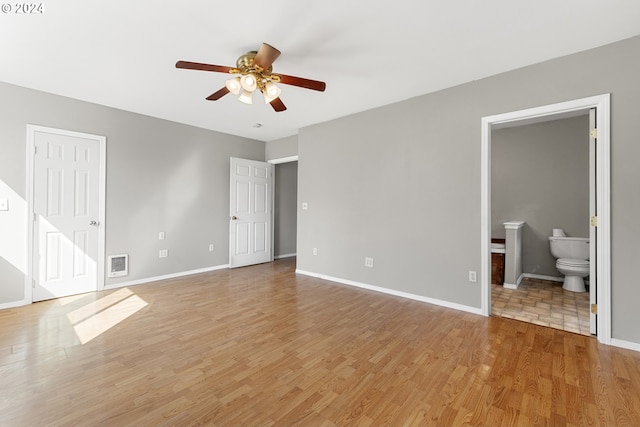 unfurnished bedroom with ceiling fan, light hardwood / wood-style floors, and ensuite bath