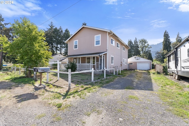 view of front of house featuring a mountain view, a garage, and an outdoor structure