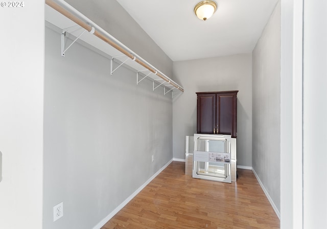 spacious closet with light hardwood / wood-style floors