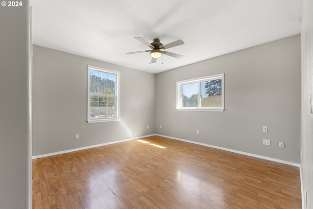 empty room featuring wood-type flooring and ceiling fan