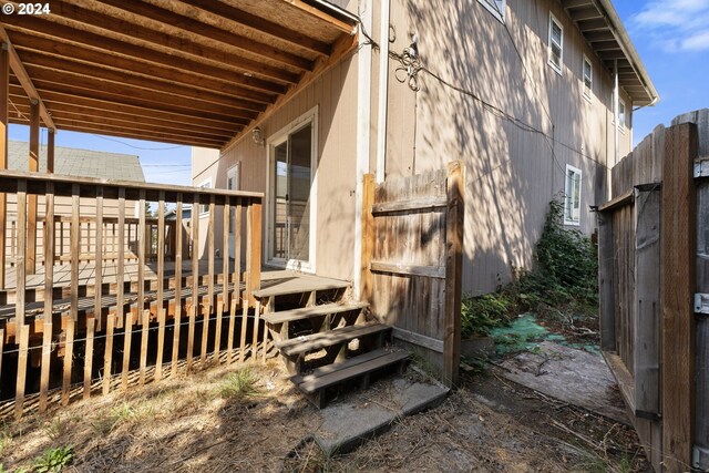 view of property exterior with a wooden deck