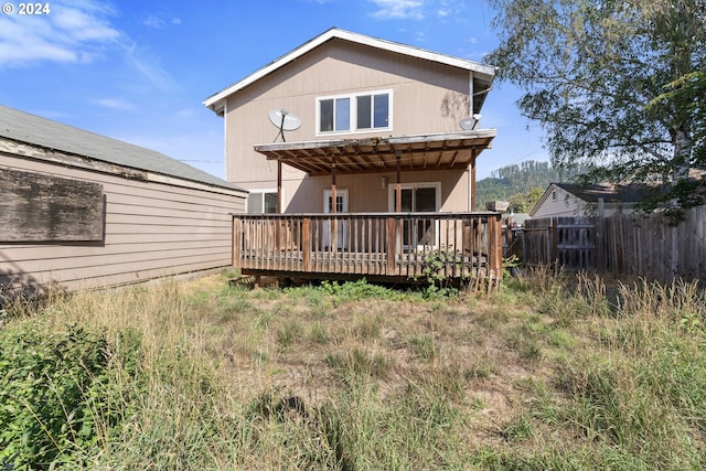 rear view of house featuring a deck