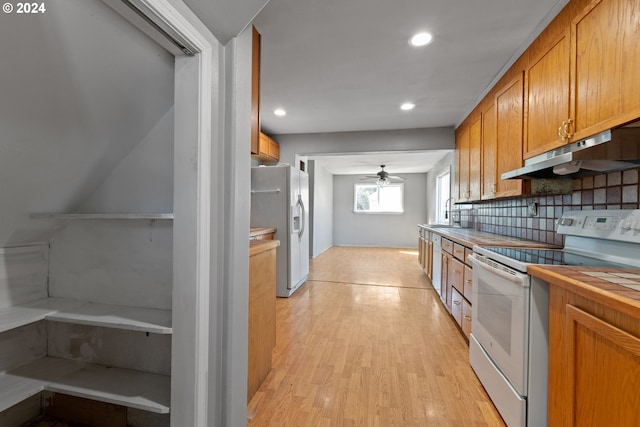 kitchen featuring backsplash, white electric stove, ceiling fan, light hardwood / wood-style flooring, and stainless steel refrigerator with ice dispenser