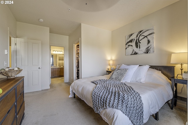 bedroom with carpet floors and ensuite bath