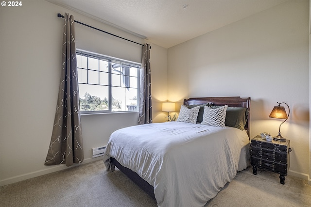 carpeted bedroom with baseboards and a baseboard heating unit