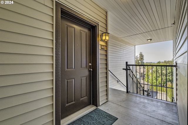 view of exterior entry featuring covered porch