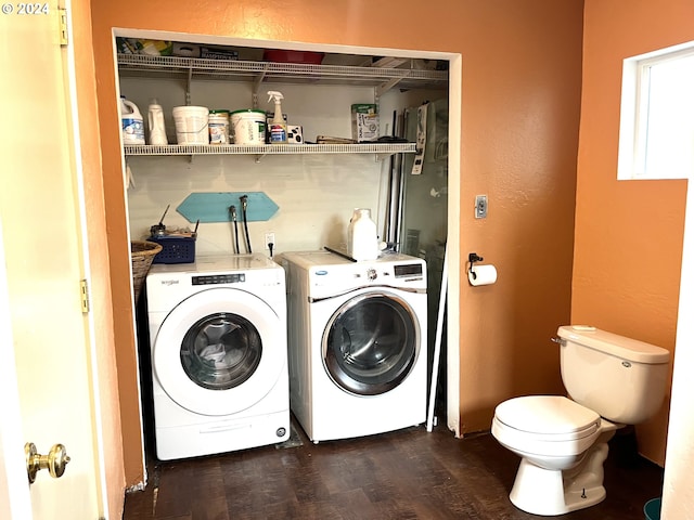 washroom featuring dark wood-style flooring, laundry area, and washer and dryer