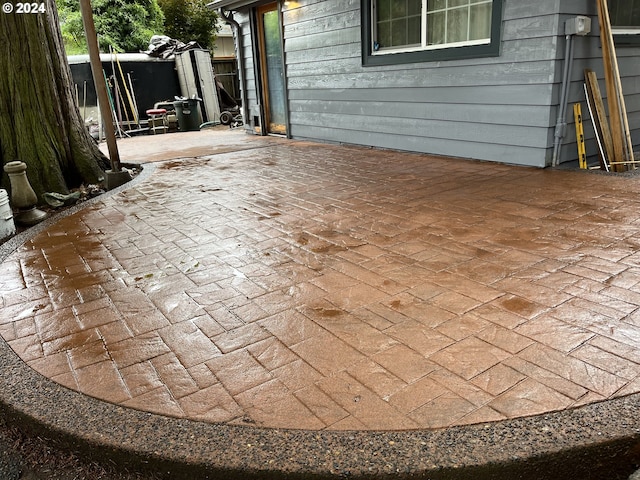 view of patio featuring a storage unit