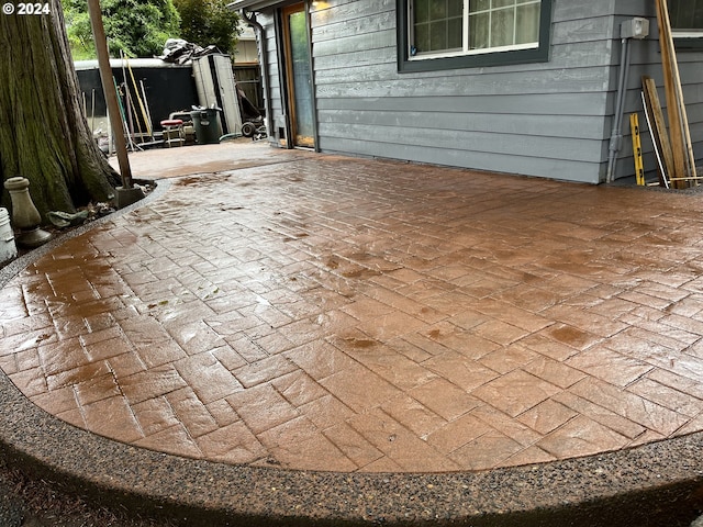 view of patio / terrace with a storage shed and an outdoor structure