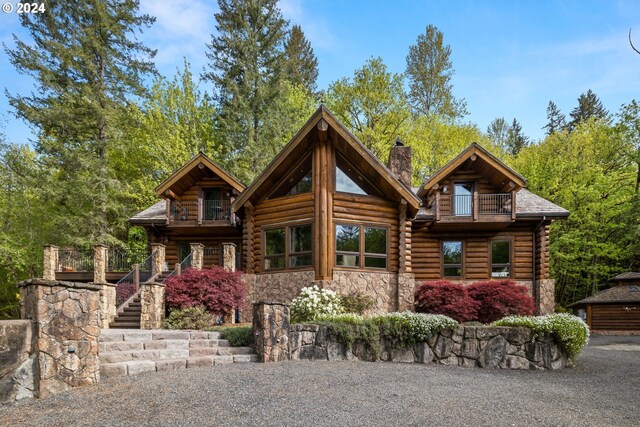 log home featuring a balcony