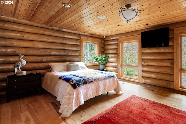 bedroom with rustic walls, light hardwood / wood-style flooring, and wooden ceiling