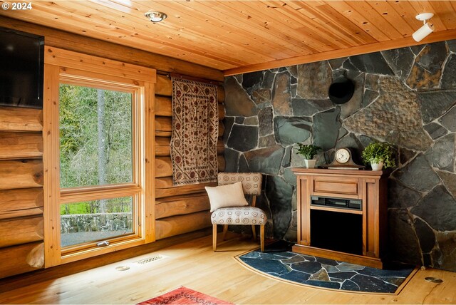 entryway with log walls and wood ceiling