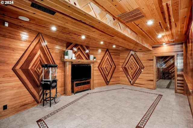 kitchen featuring a breakfast bar, beverage cooler, wooden walls, wooden ceiling, and a kitchen island