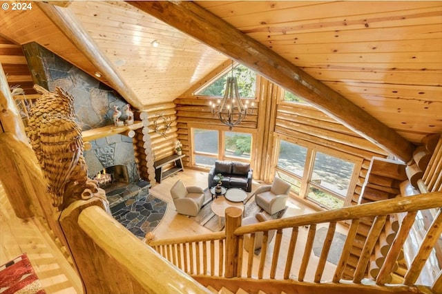 living room featuring wood ceiling, a fireplace, and log walls