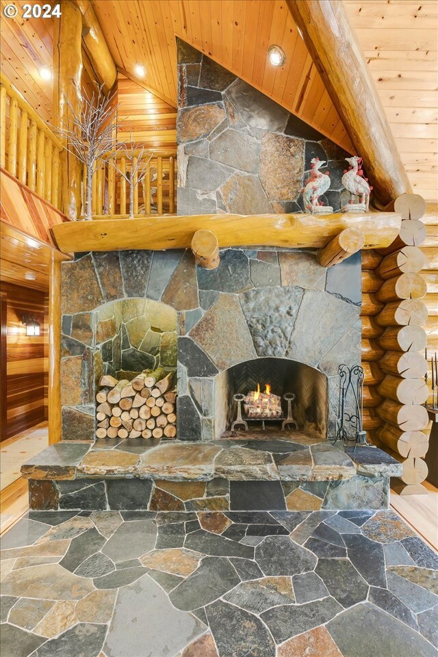 living room featuring a fireplace, wooden ceiling, and log walls