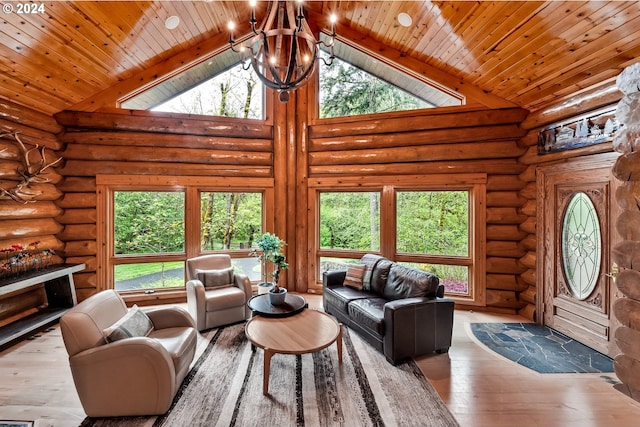 living room featuring light wood-type flooring, an inviting chandelier, and a healthy amount of sunlight