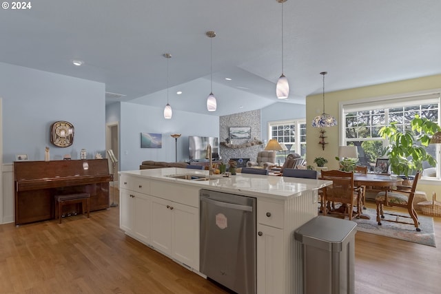 kitchen featuring white cabinets, dishwasher, decorative light fixtures, and a kitchen island with sink