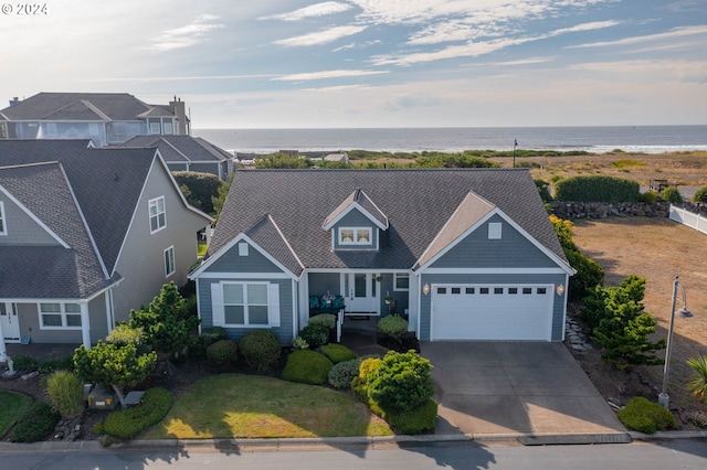 view of front facade featuring a garage and a water view