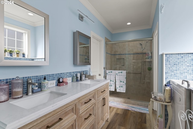 bathroom featuring hardwood / wood-style flooring, crown molding, vanity, and an enclosed shower