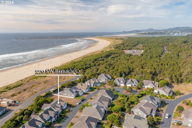 bird's eye view with a view of the beach and a water view