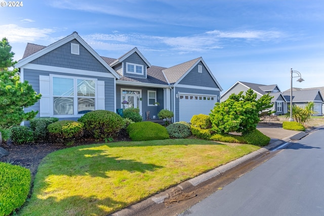 view of front of house featuring a front yard and a garage