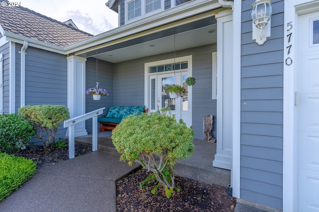 view of exterior entry with a porch