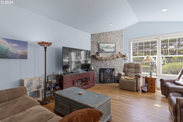 living room with light wood-type flooring and lofted ceiling