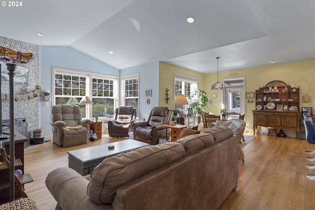 living room with light hardwood / wood-style flooring and lofted ceiling