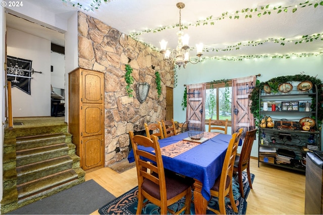 dining room featuring an inviting chandelier and light hardwood / wood-style flooring