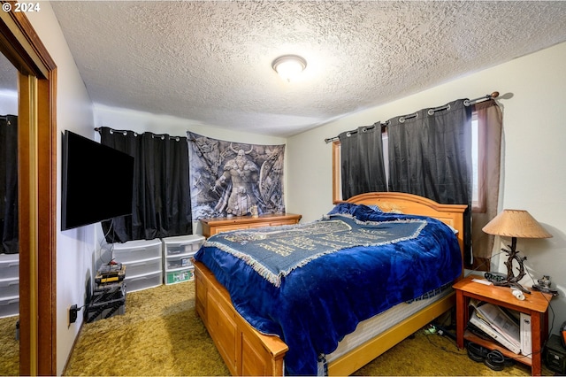 bedroom with carpet flooring and a textured ceiling