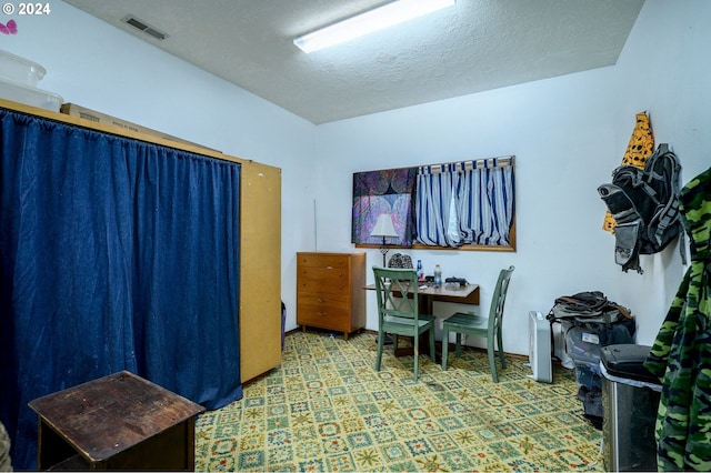 office area with a textured ceiling