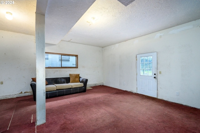 living room featuring carpet flooring and a textured ceiling