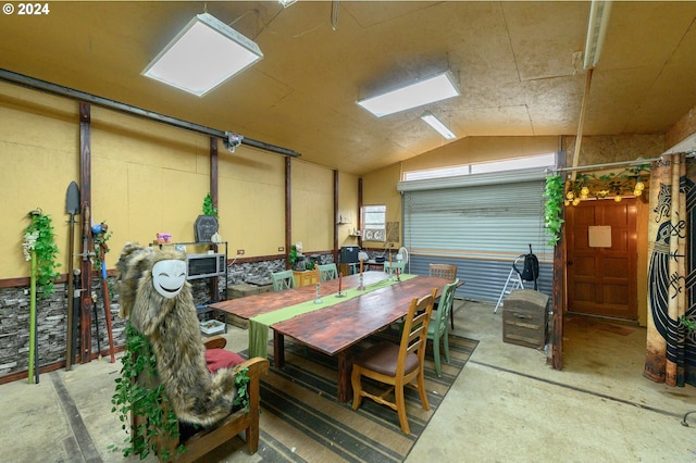 interior space with concrete floors and vaulted ceiling