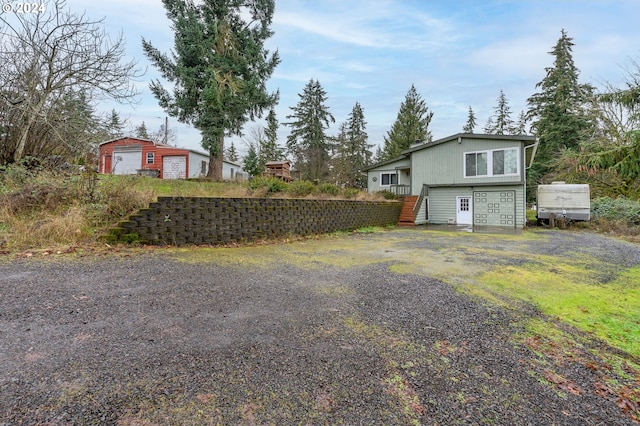 view of side of property featuring an outbuilding and a garage