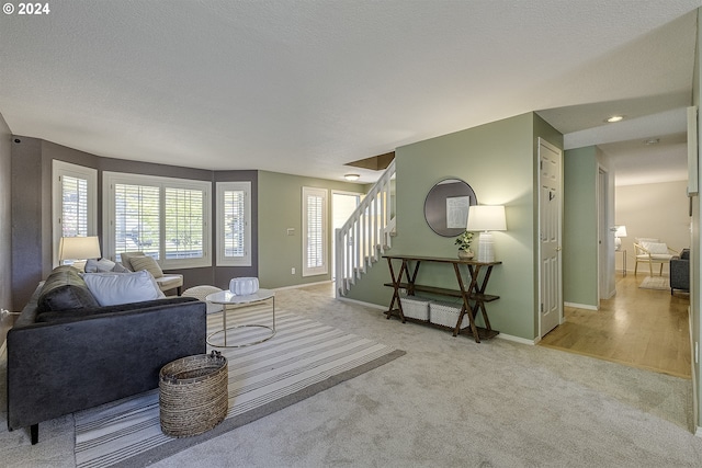 living room featuring light hardwood / wood-style flooring and a textured ceiling